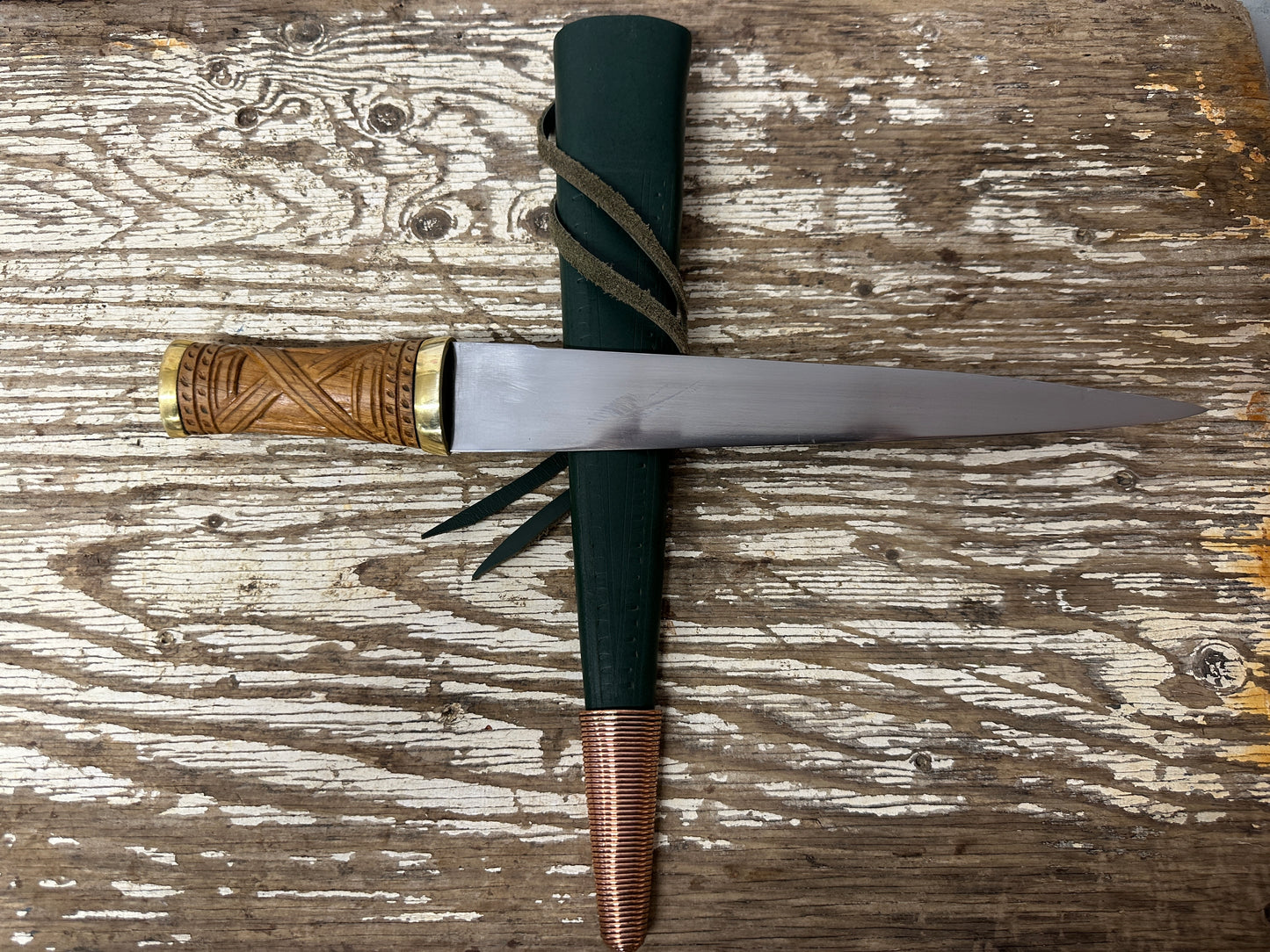 
                  
                    short irish skean in a green scabbard
                  
                