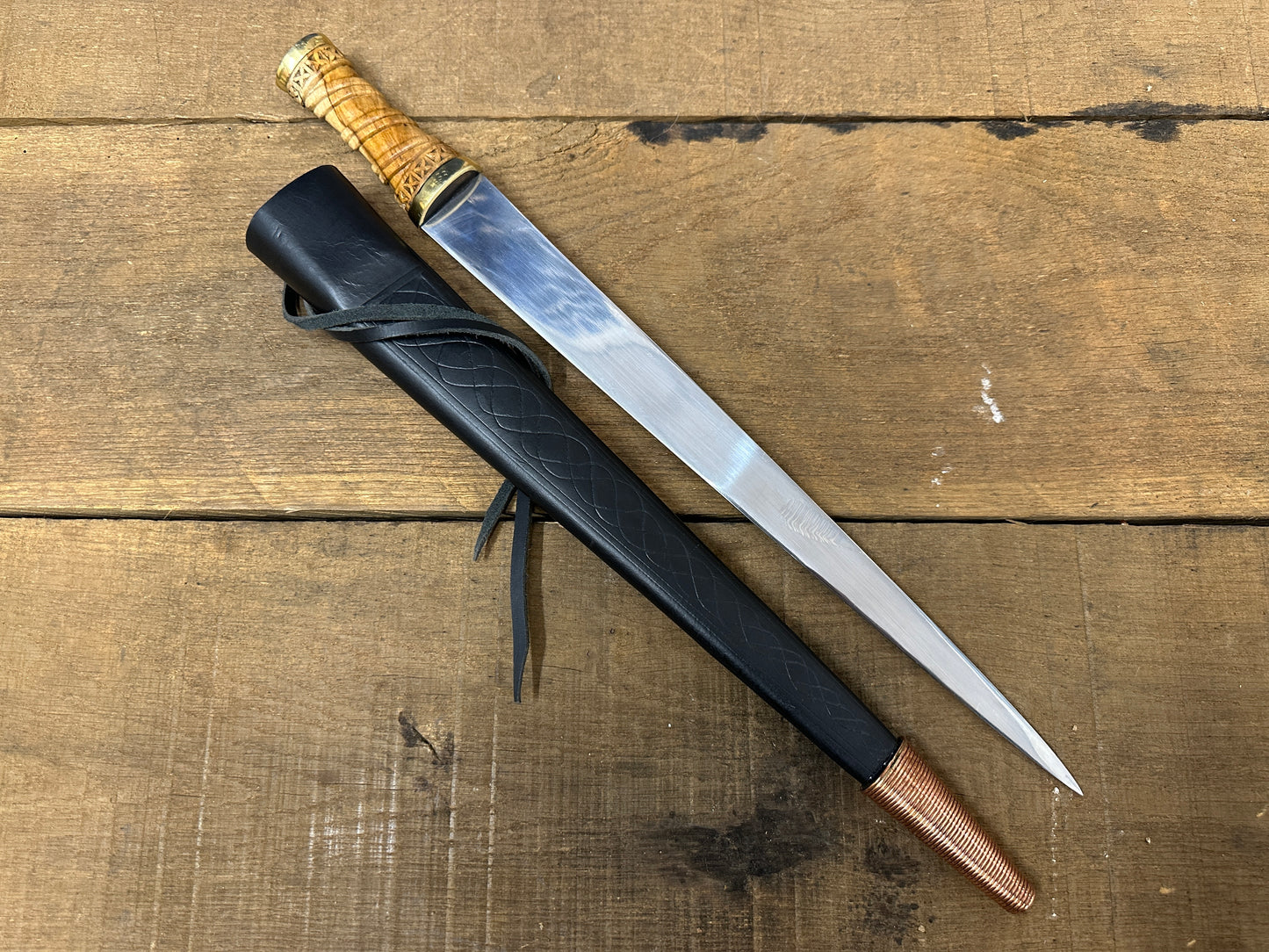
                  
                    Long Irish Skean with a black scabbard
                  
                