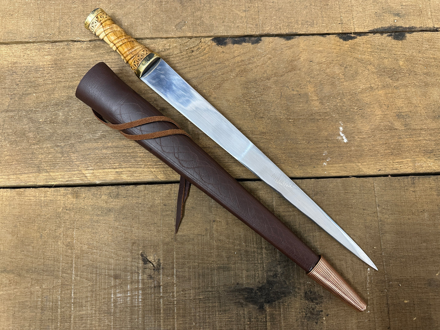 
                  
                    Long Irish Skean with a brown scabbard 
                  
                