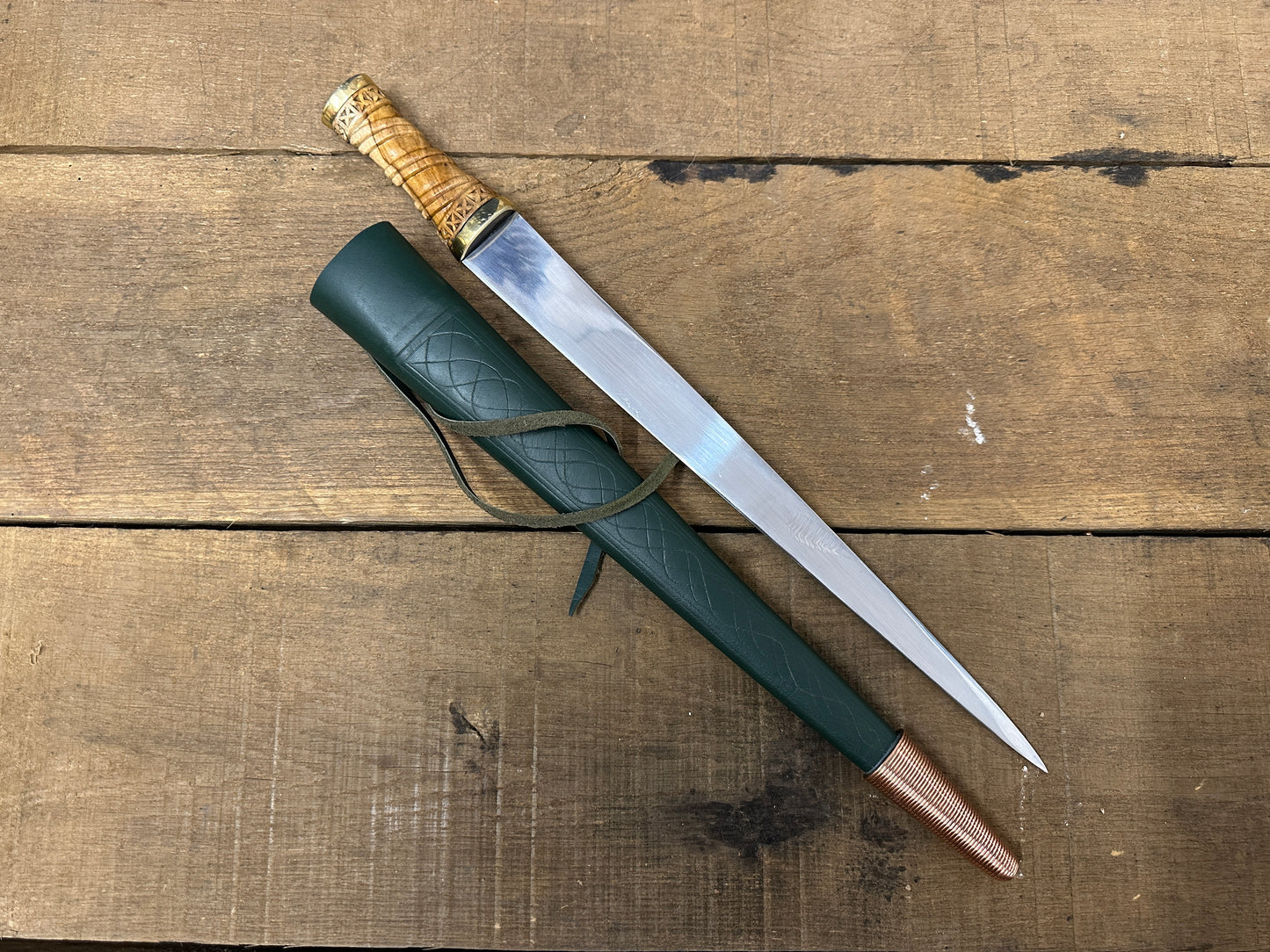 
                  
                    Long Irish Skean with a green scabbard
                  
                