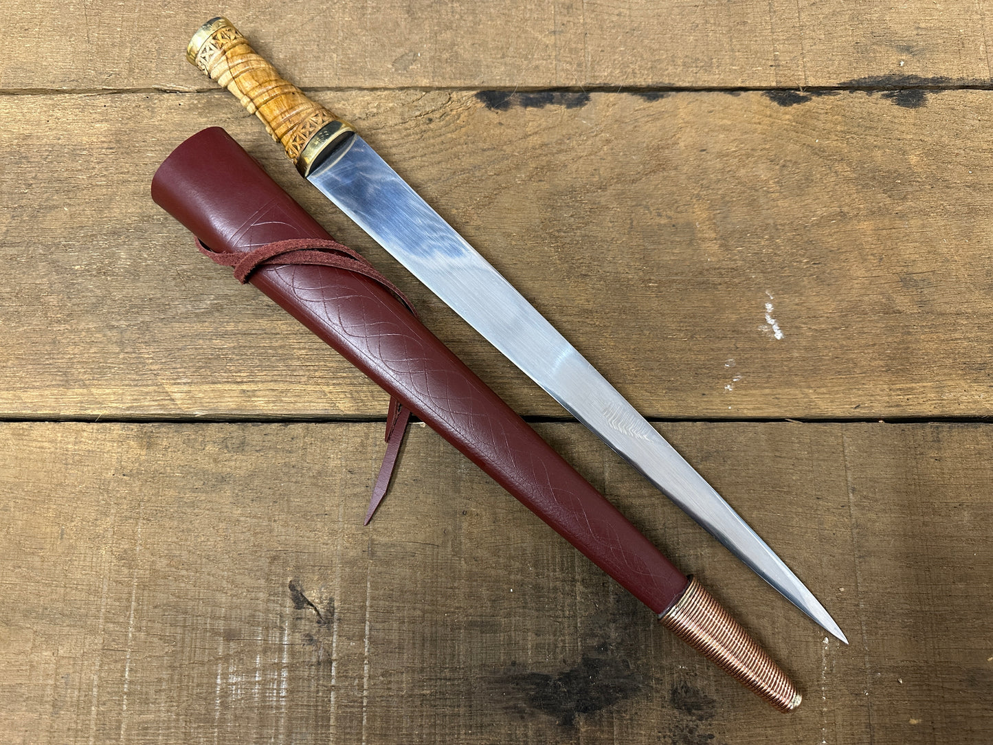 
                  
                    Long Irish Skean with a red scabbard
                  
                