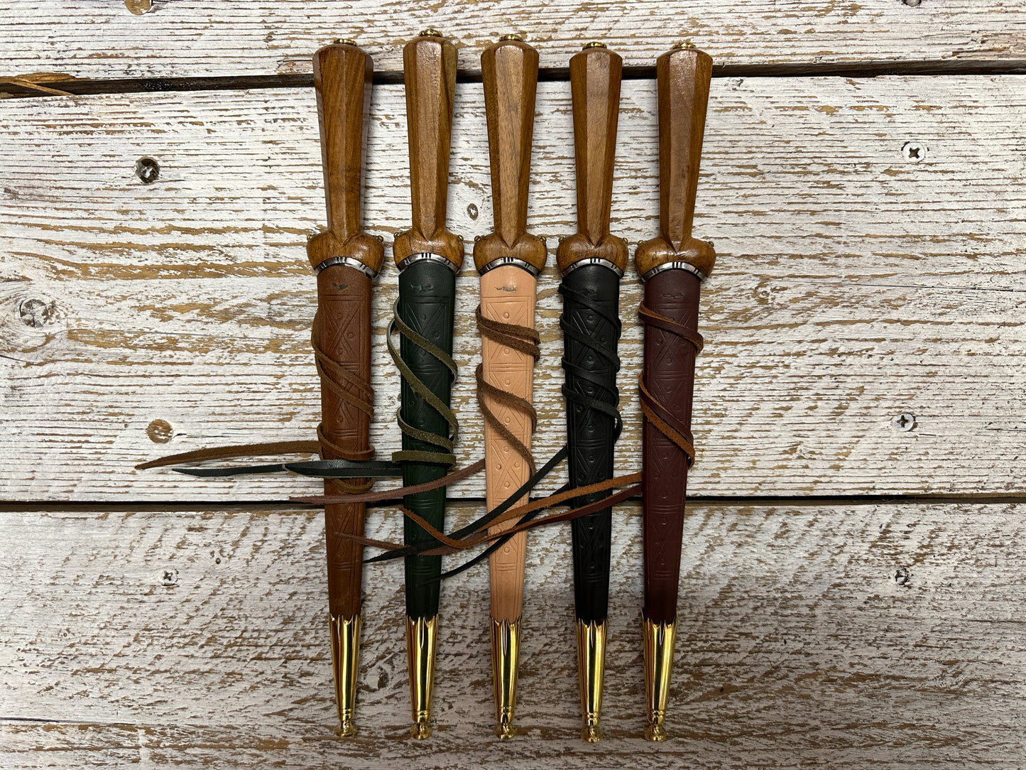 5 Dudgeon Daggers in brown, green, natural, black and red scabbards
