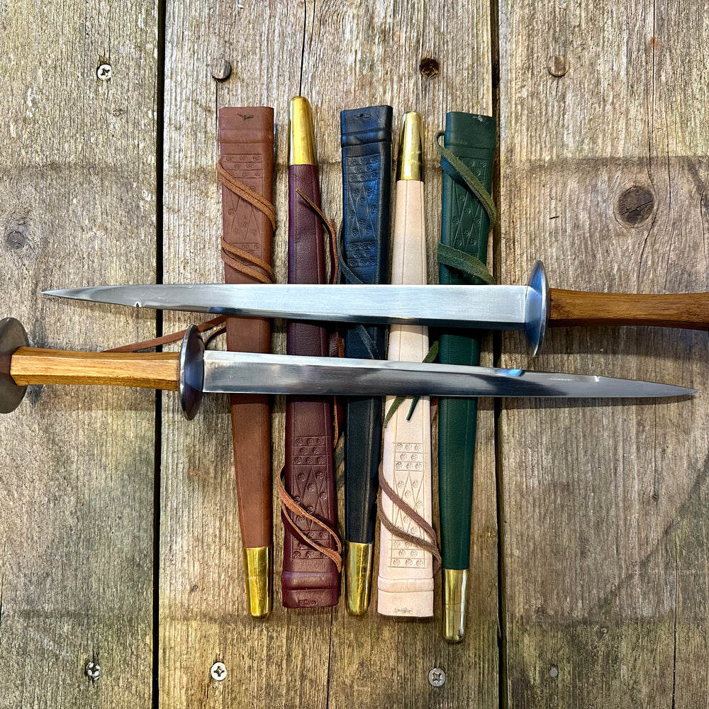 
                  
                    Tod Cutler Rondels on leather scabbards
                  
                