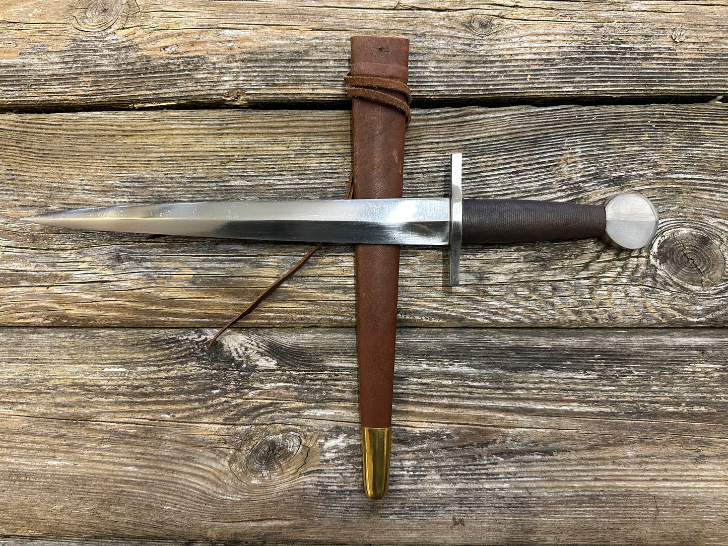 
                  
                    12-17thC Quillon Dagger with a brown scabbard

                  
                