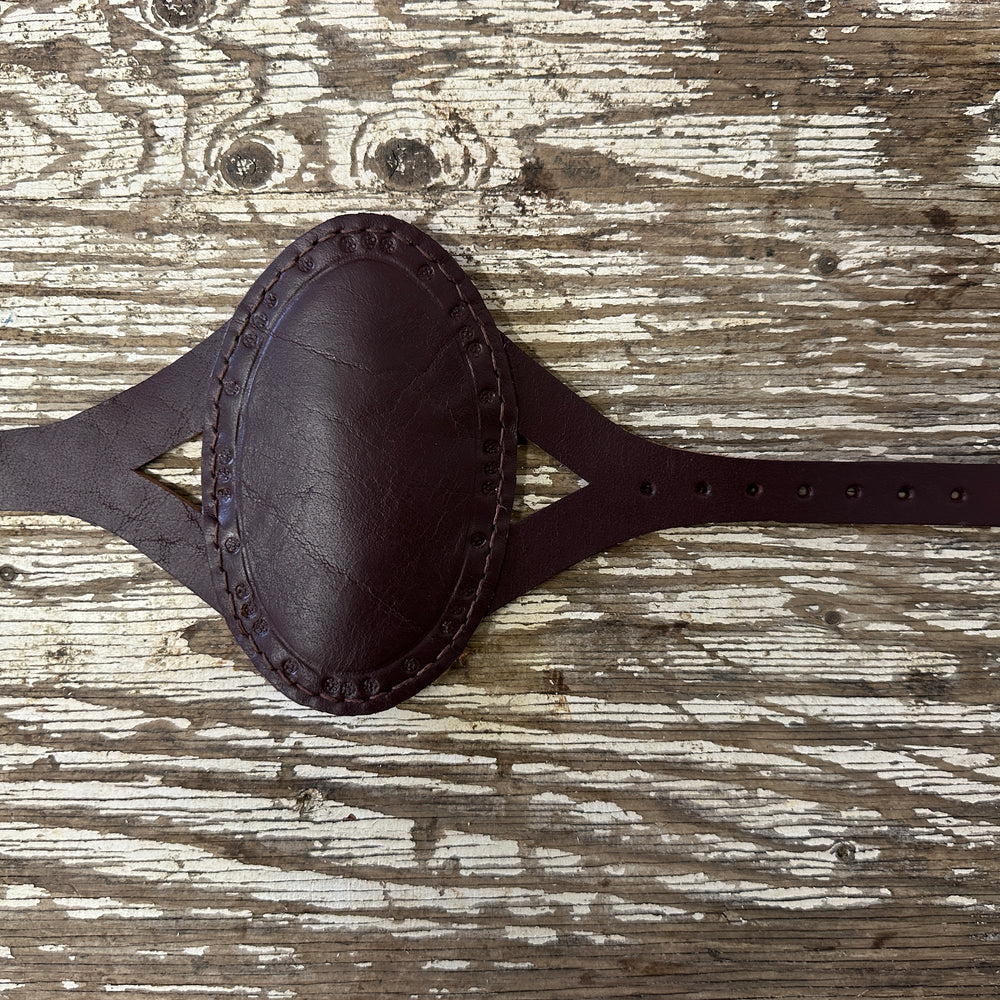 
                  
                    Oval archery bracer in red
                  
                