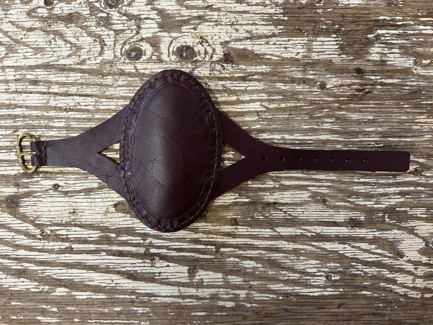 
                  
                    Oval archery bracer in red
                  
                