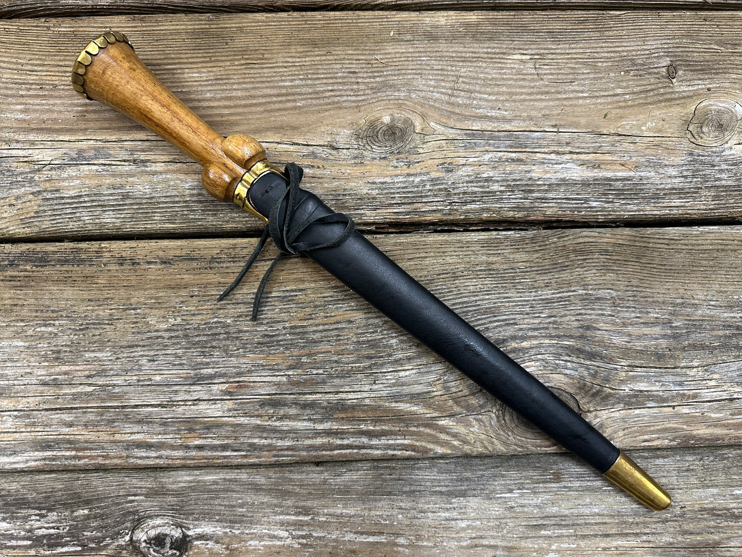 
                  
                    Mid status bollock dagger in a black scabbard
                  
                