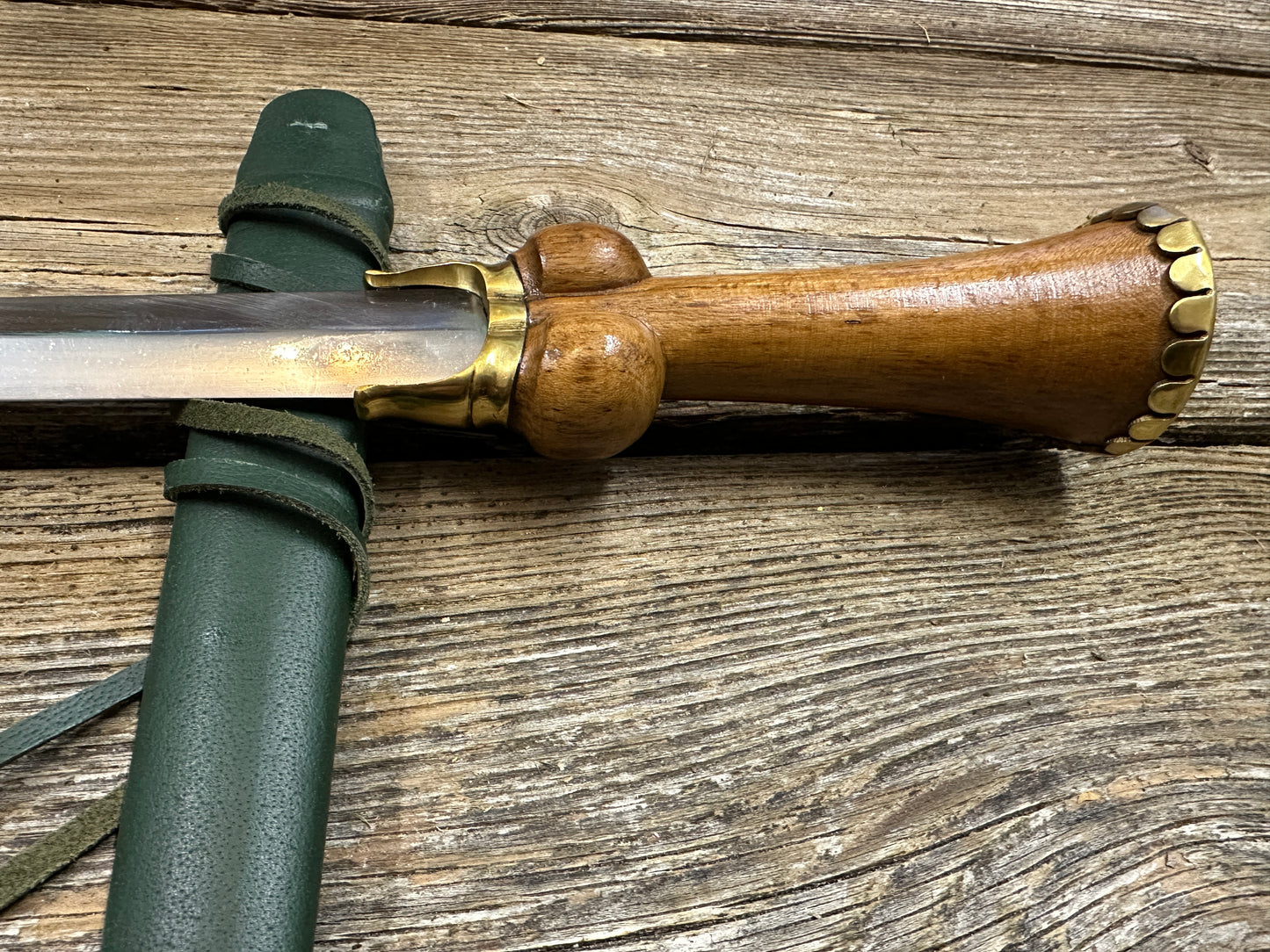 
                  
                    Mid status bollock dagger with a green scabbard
                  
                