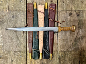 
                  
                    Tod Cutler Scottish Dirk resting on all five colours of scabbard
                  
                