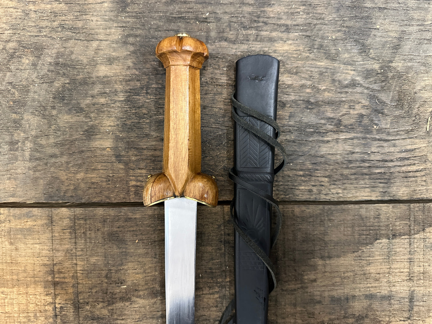 
                  
                    A Mary Rose Bollock Dagger with a black scabbard. 
                  
                