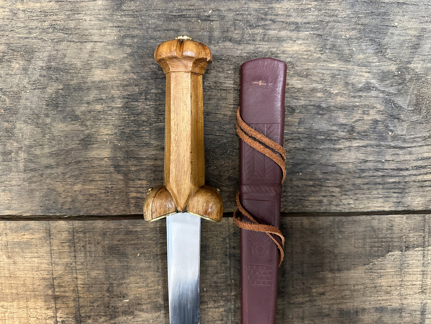
                  
                    A Mary Rose Bollock Dagger with a red scabbard. 
                  
                