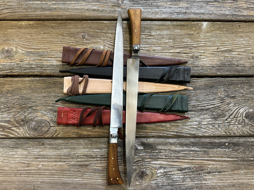 Rugger Bauernwehr. Two knives on brown, black, natural, green and red scabbards. 