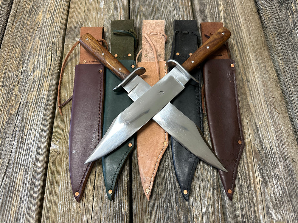 Two Bowie knives crossed on red, green, natural, black and brown scabbards