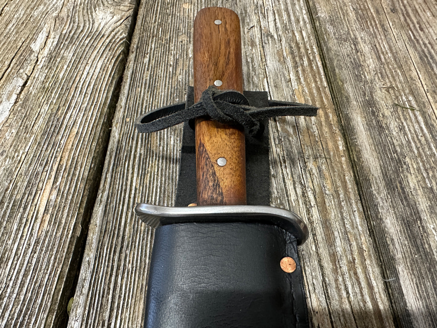 
                  
                    Bowie knife with black scabbard
                  
                