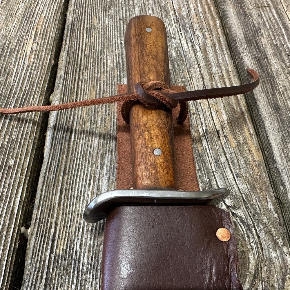 
                  
                    Bowie knife with brown scabbard
                  
                