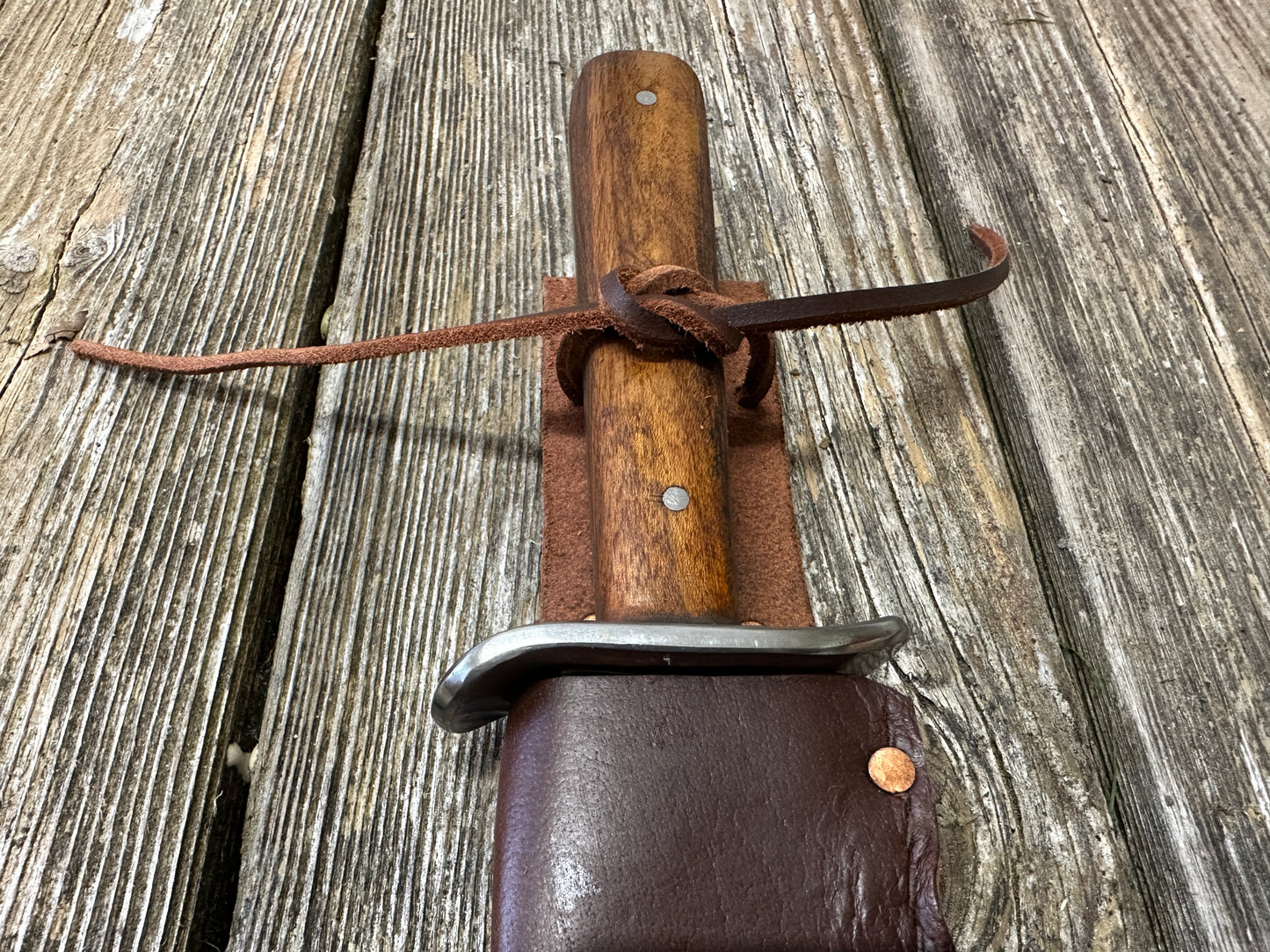 
                  
                    Bowie knife with brown scabbard
                  
                