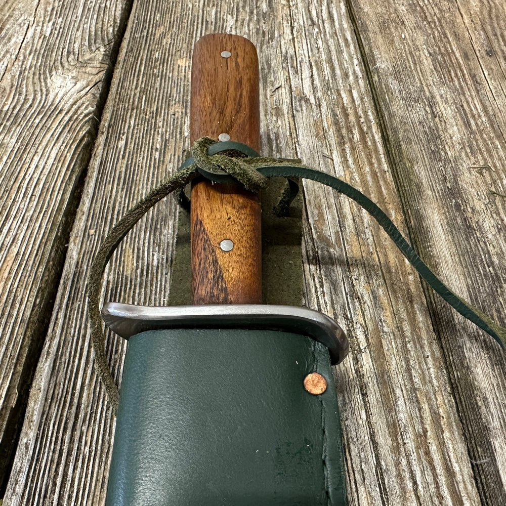 
                  
                    Bowie knife with green scabbard
                  
                