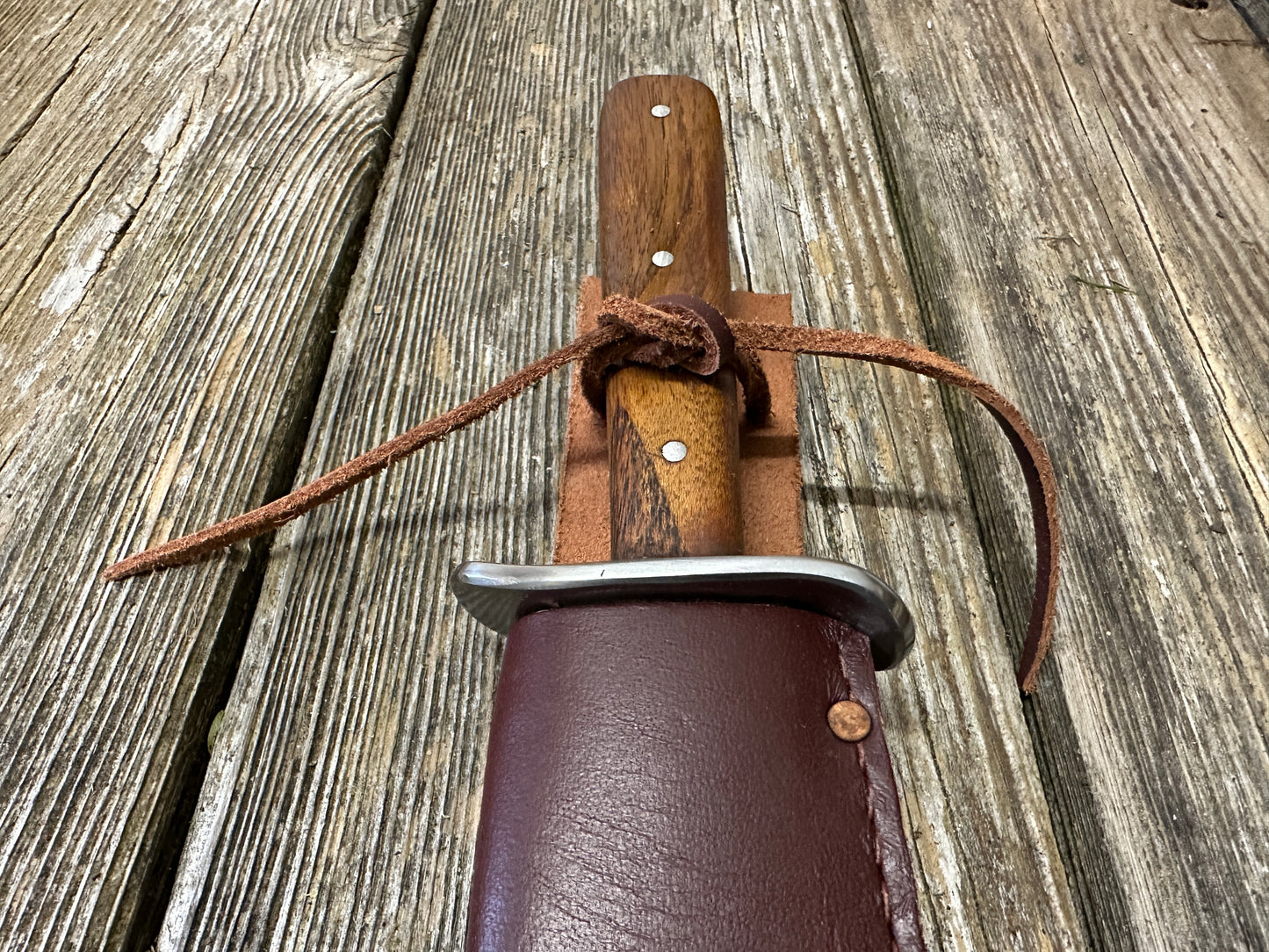 
                  
                    Bowie knife with red scabbard
                  
                