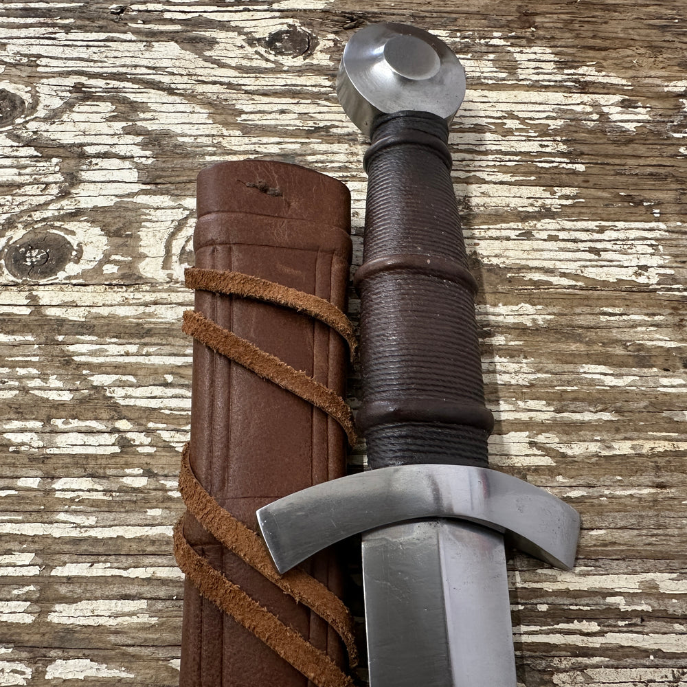 
                  
                    14thC Quillon Dagger with a brown 
scabbard
                  
                