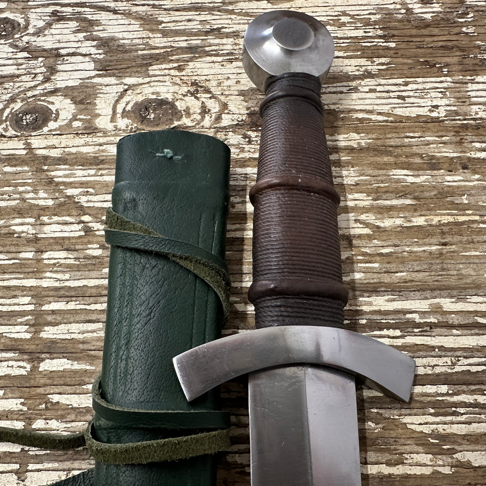 
                  
                    14thC Quillon Dagger with a green scabbard
                  
                