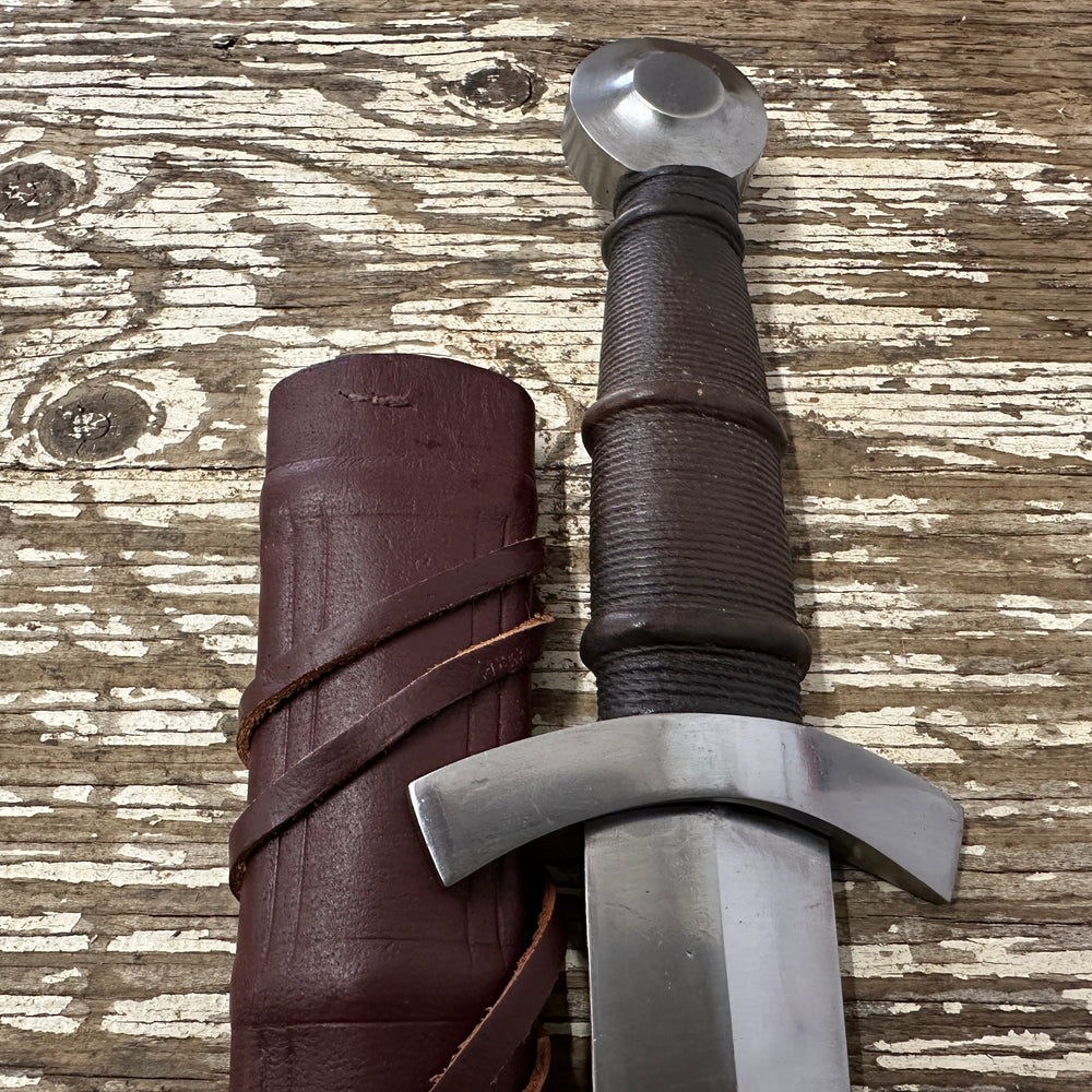 
                  
                    14thC Quillon Dagger with a red scabbard
                  
                