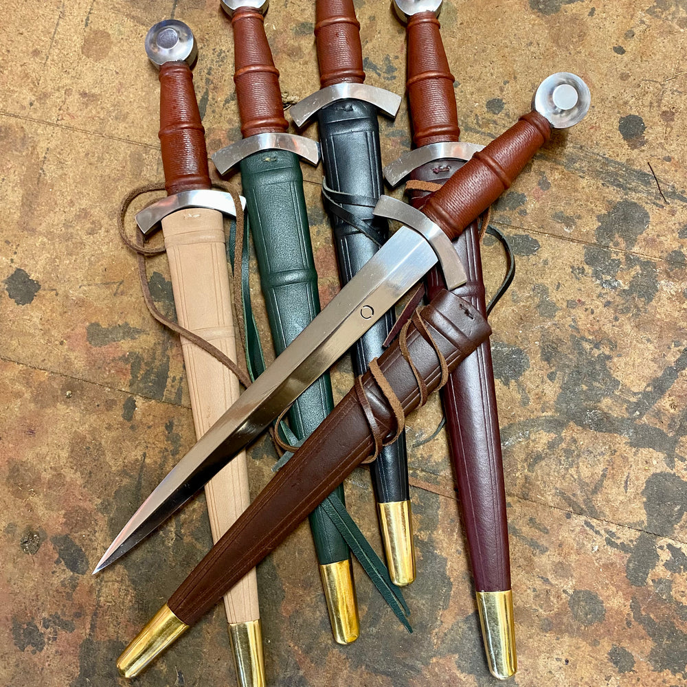 
                  
                    Tod Cutler Quillon daggers with green, red, black, brown and natural scabbards
                  
                