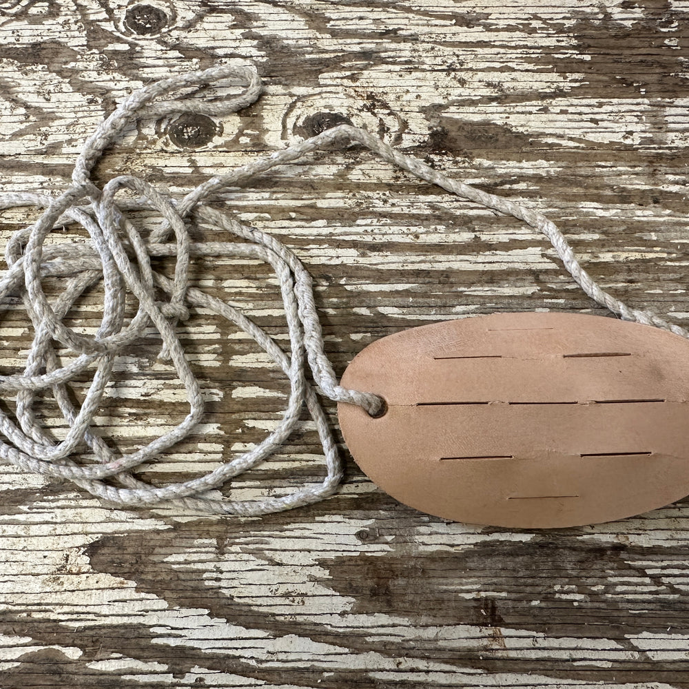 Leather and string make up this sling