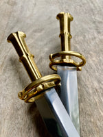 two S Quillon dagger grips close up