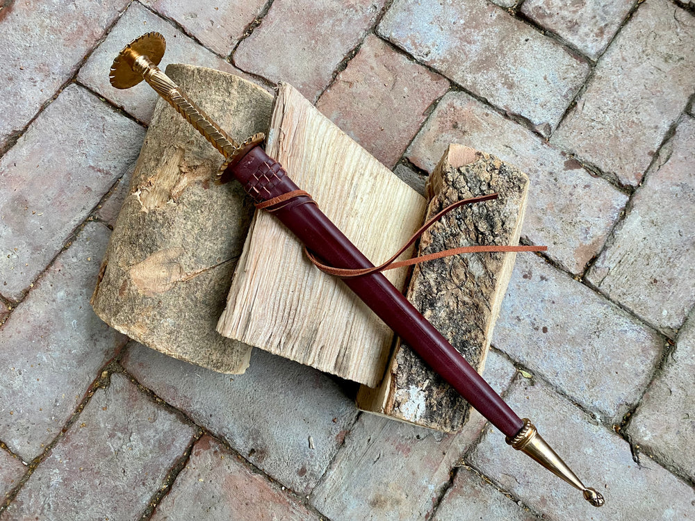 
                  
                    Tod Cutler bronze hilted rondel on a brick background
                  
                