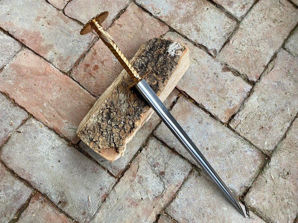 Tod Cutler bronze hilted rondel on a brick background