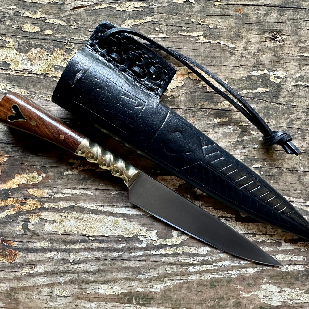 
                  
                    Heart eating knife with a black sheath
                  
                