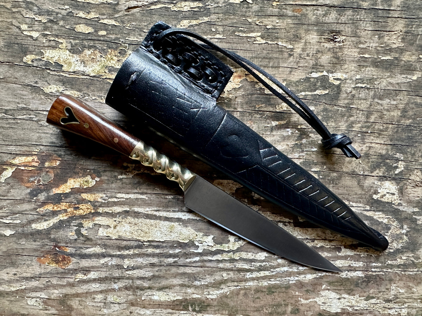 
                  
                    Heart eating knife with a black sheath
                  
                