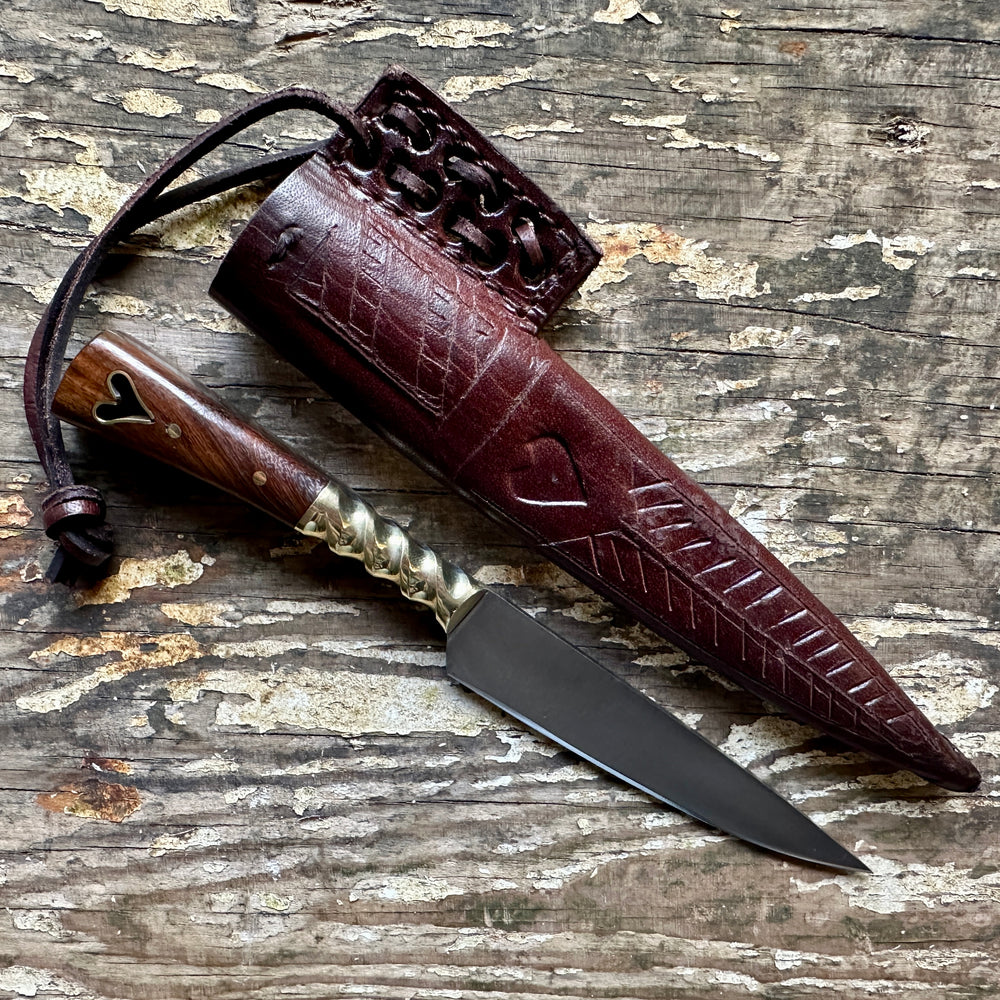 
                  
                    Heart eating knife with a brown sheath
                  
                