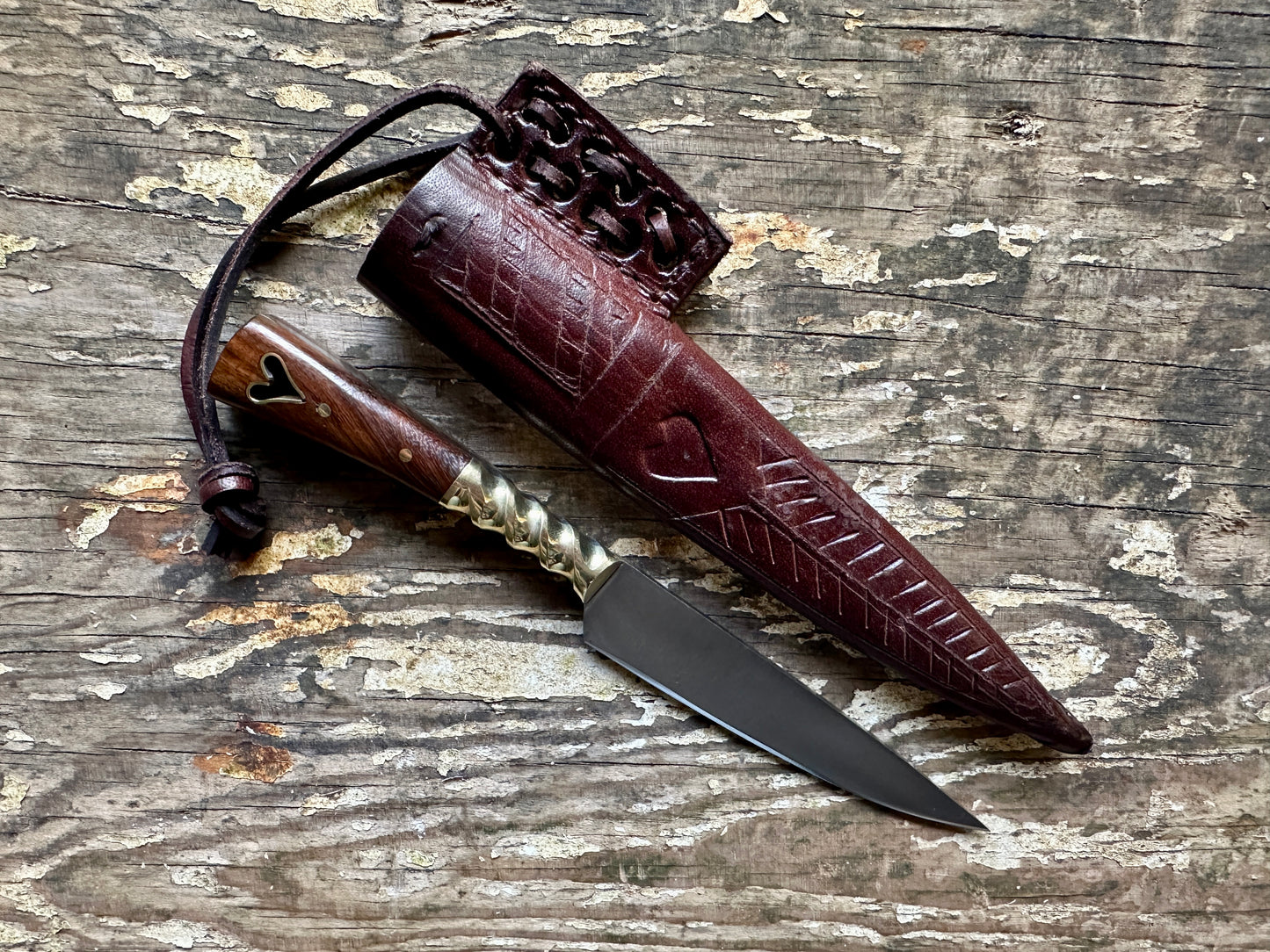 
                  
                    Heart eating knife with a brown sheath
                  
                