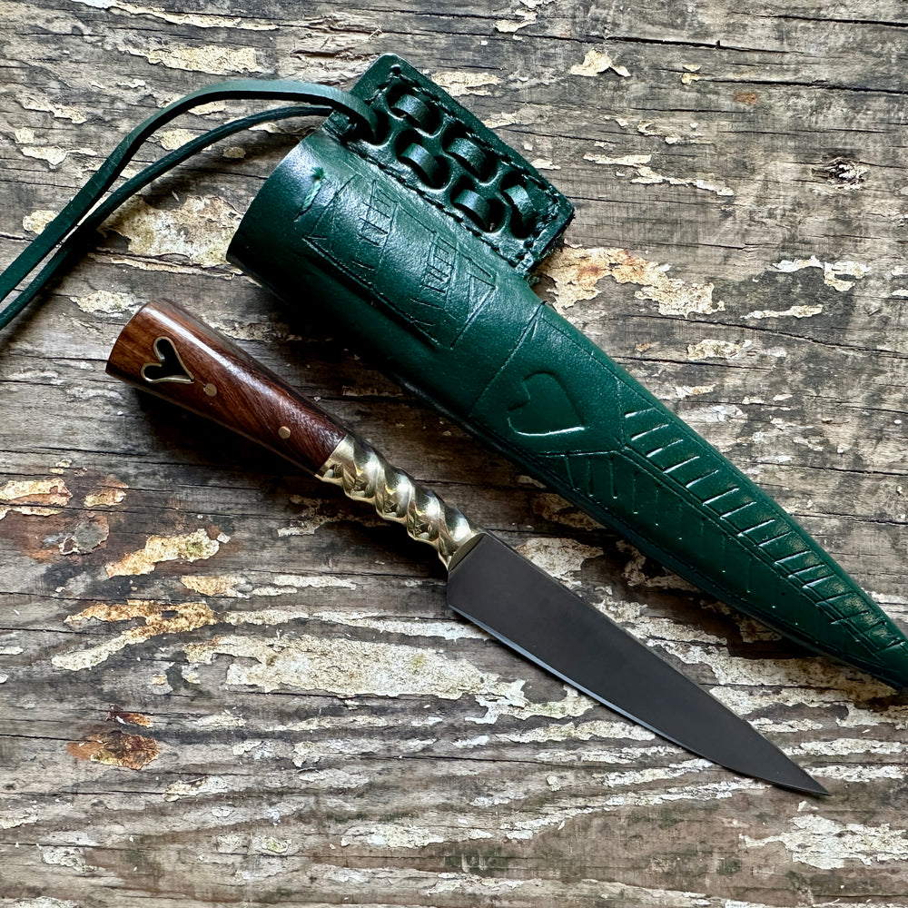 
                  
                    Heart eating knife with a green sheath
                  
                