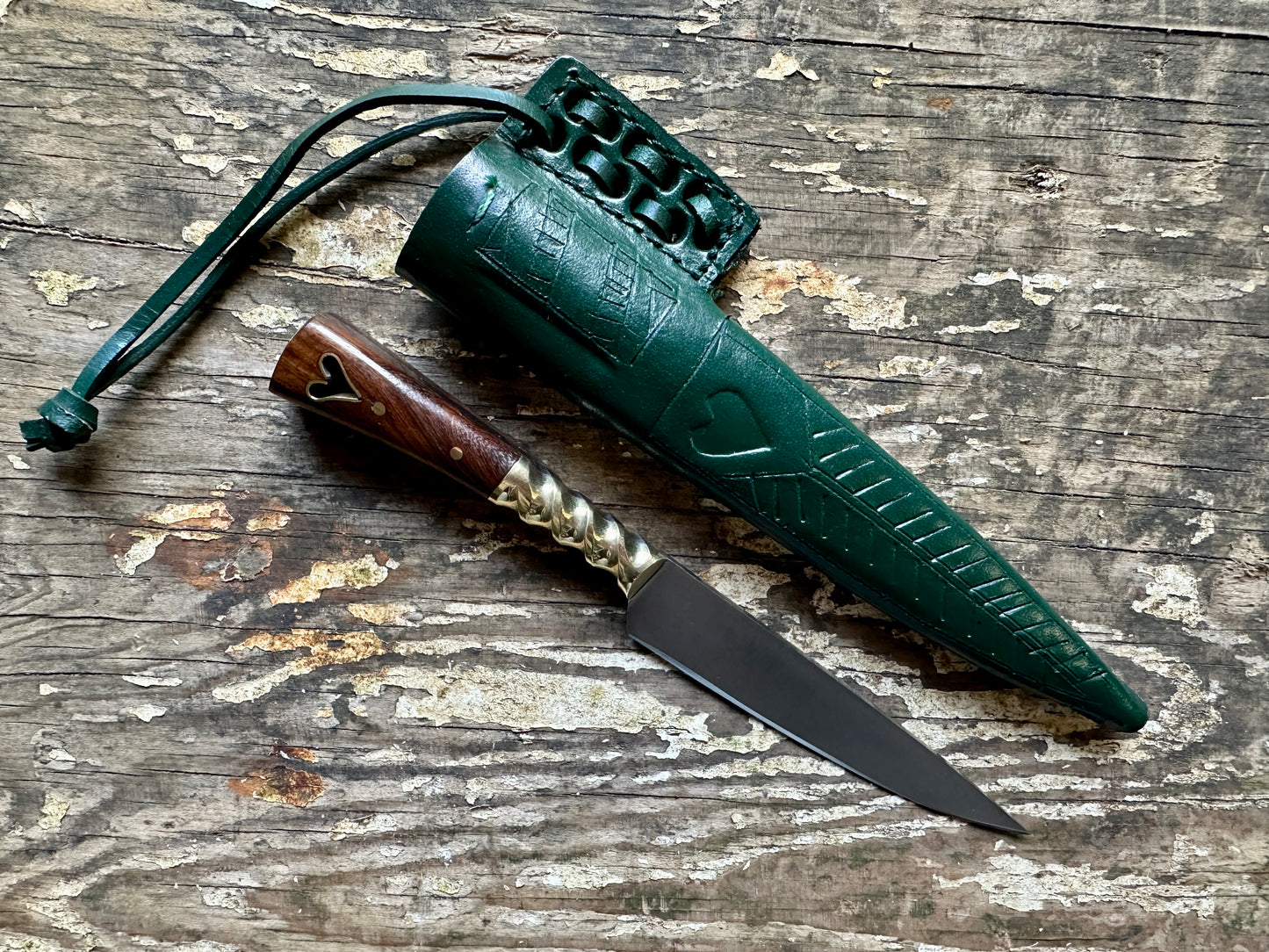 
                  
                    Heart eating knife with a green sheath
                  
                