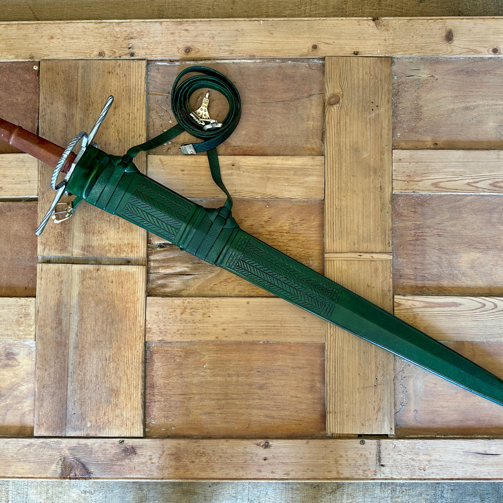 
                  
                    German War Sword in a green scabbard
                  
                