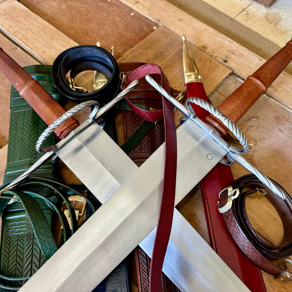 
                  
                    German War Sword. Close up of two crossed swords on pile of scabbards. 
                  
                