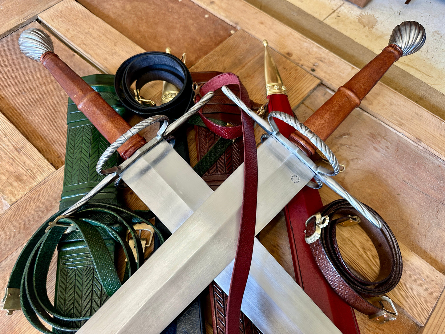 
                  
                    German War Sword. Close up of two crossed swords on pile of scabbards. 
                  
                