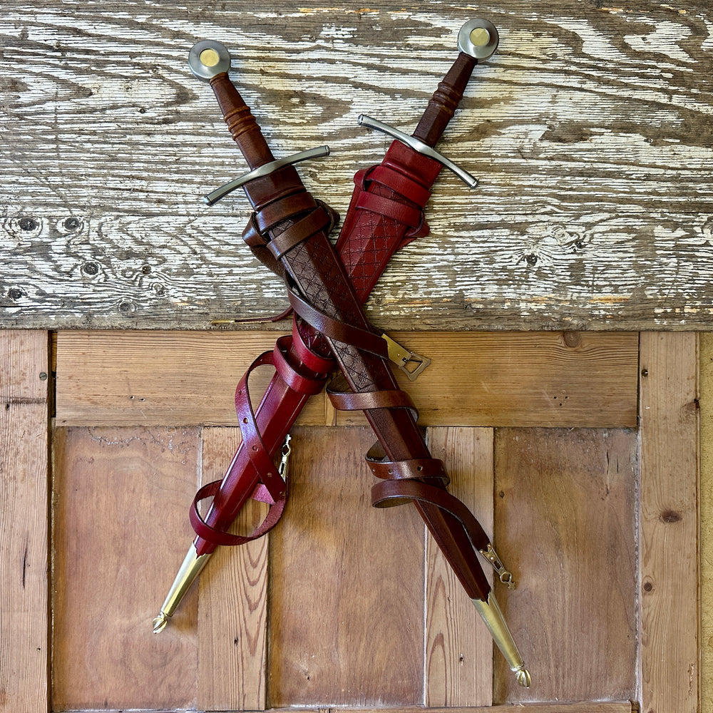 
                  
                    two swords, one in a red and one in a brown scabbard.

                  
                