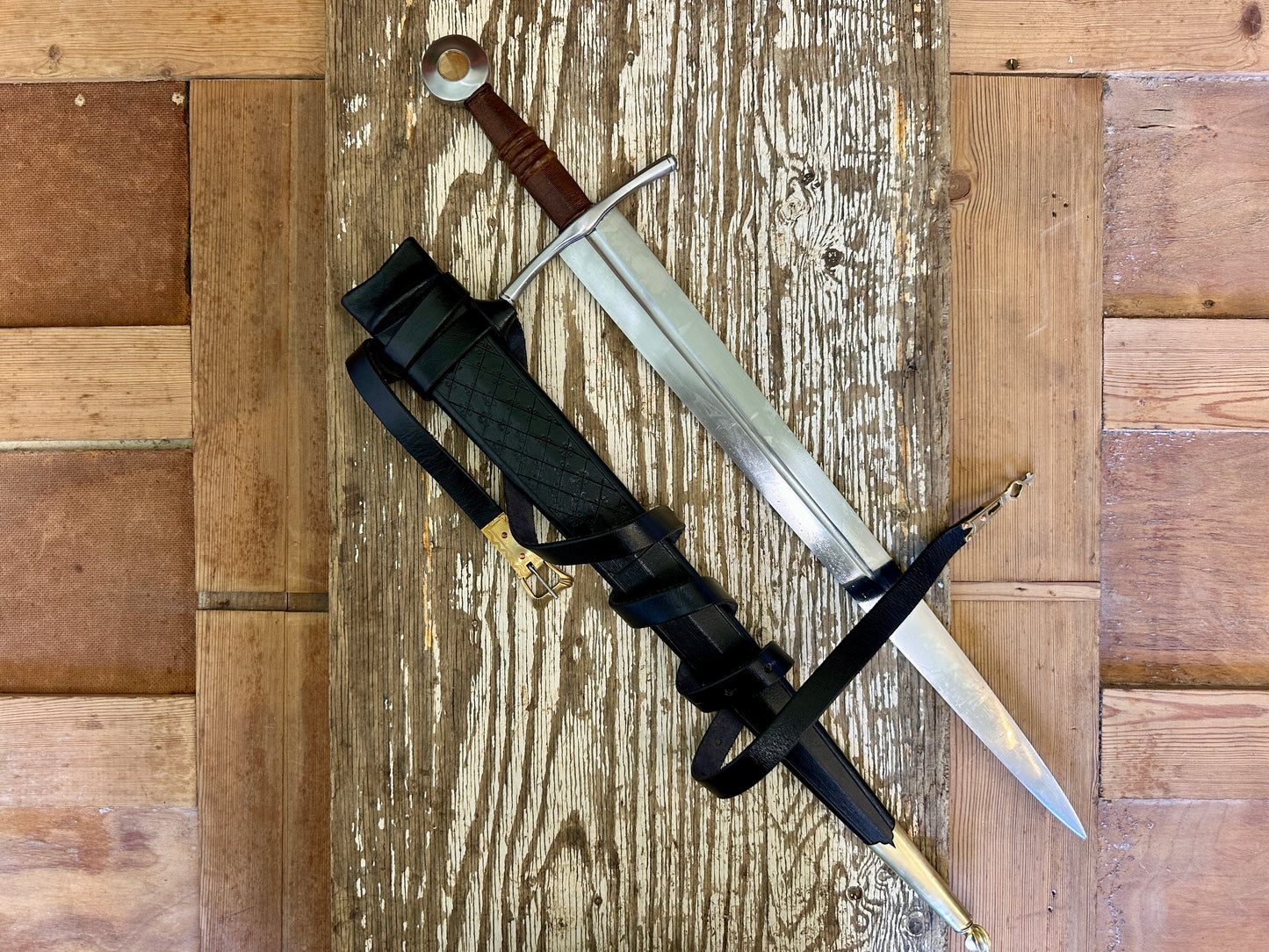 
                  
                    Coustille sword with a black scabbard
                  
                