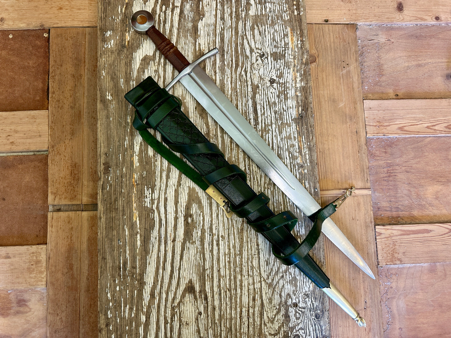 
                  
                    Coustille sword with a green scabbard
                  
                