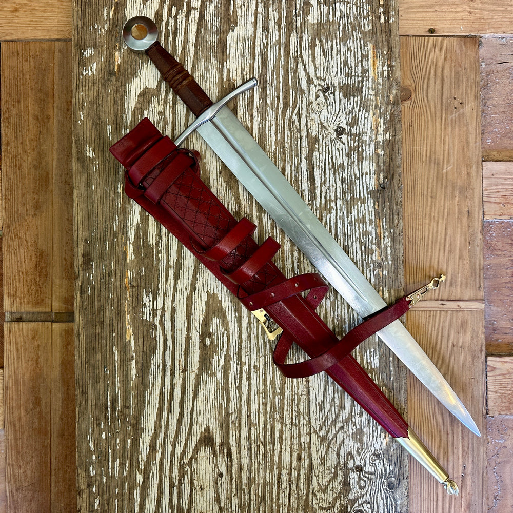 
                  
                    Coustille sword with a red scabbard
                  
                