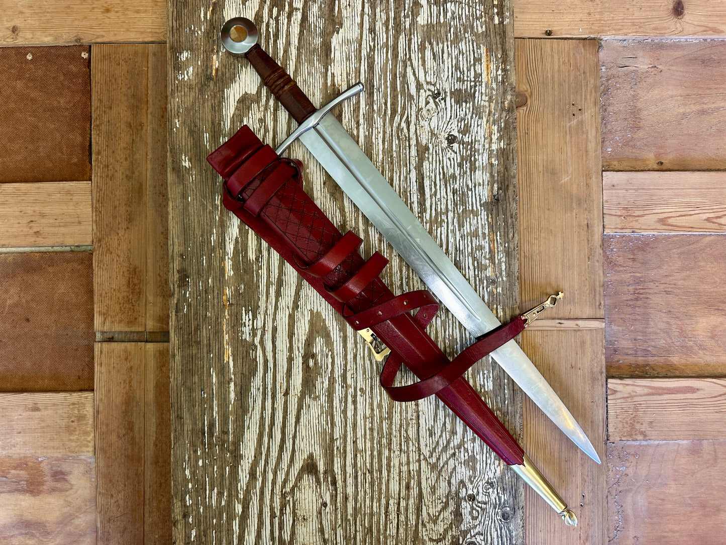 
                  
                    Coustille sword with a red scabbard
                  
                