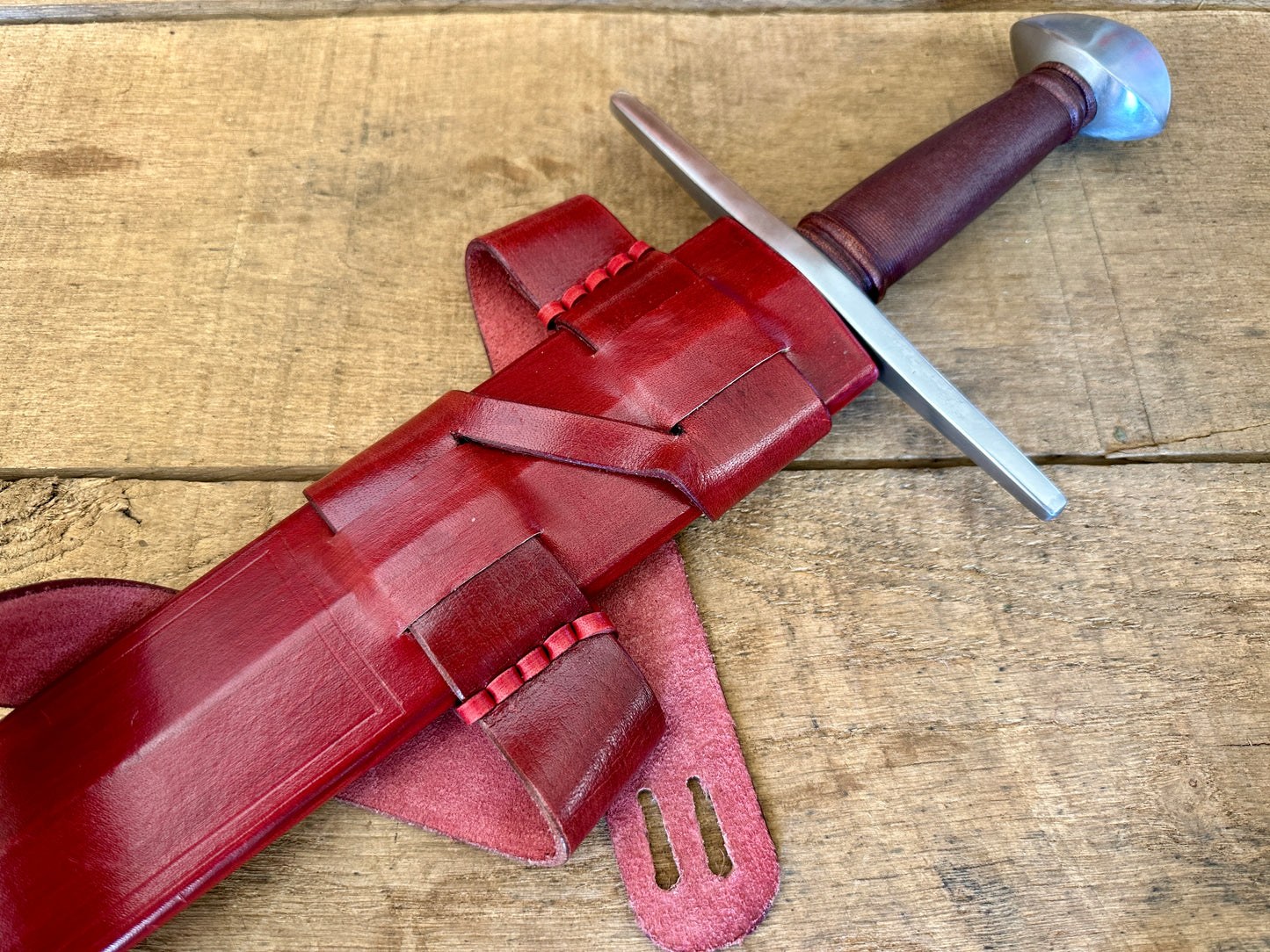 
                  
                    Viking Norman Brazil Nut Sword in a red scabbard 
                  
                