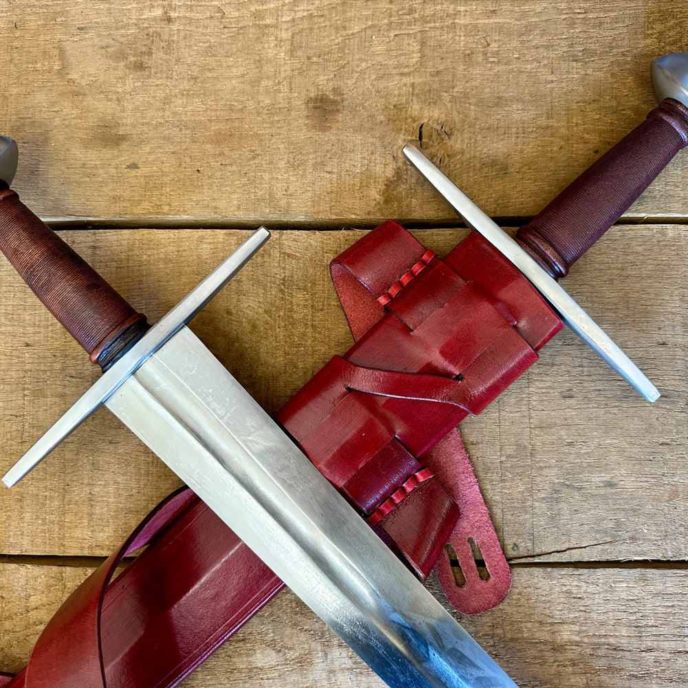 
                  
                    Viking Norman Brazil Nut Sword one in a red scabbard, one out
                  
                