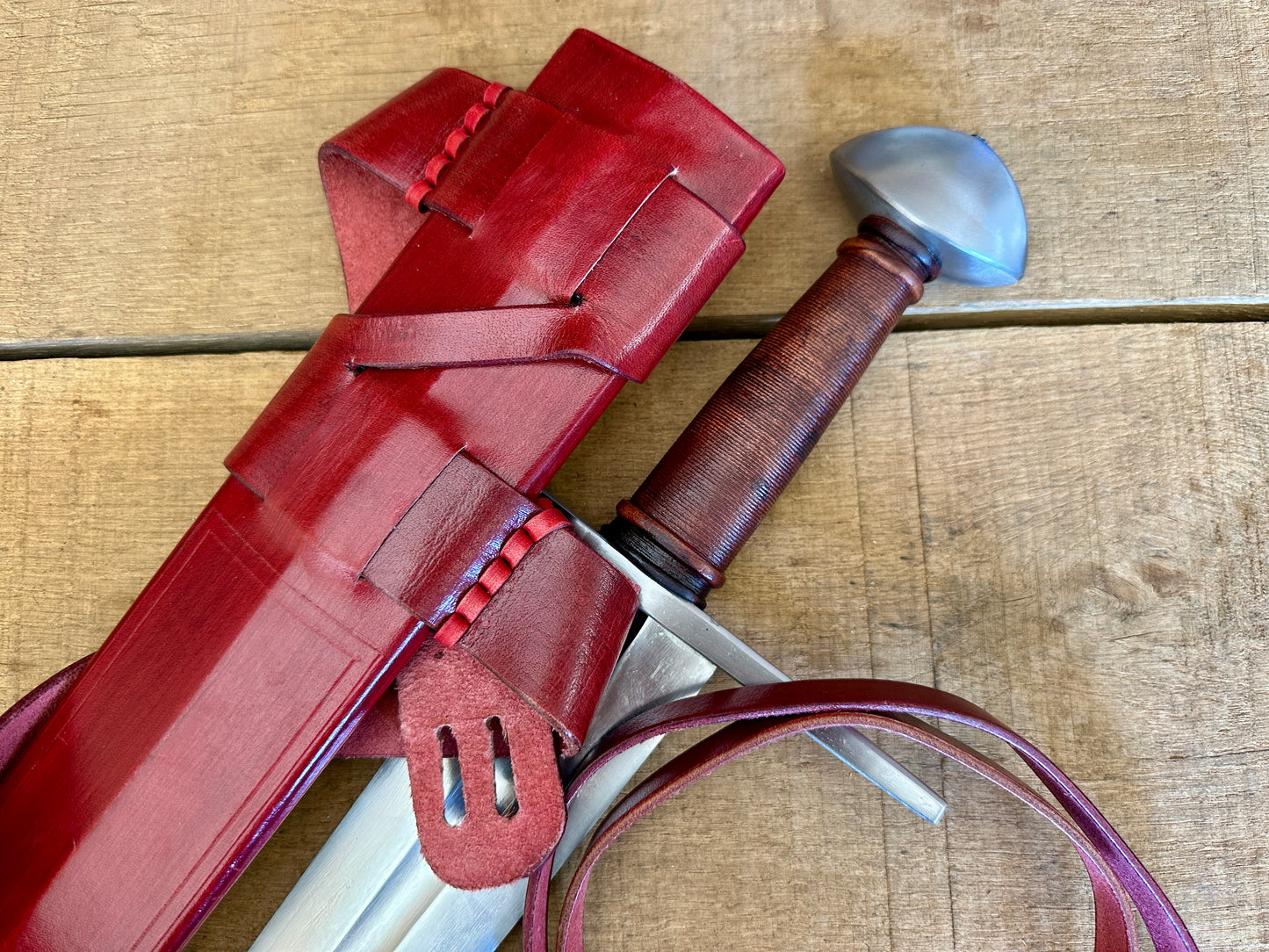 
                  
                    Viking Norman Brazil Nut Sword with a red scabbard 
                  
                