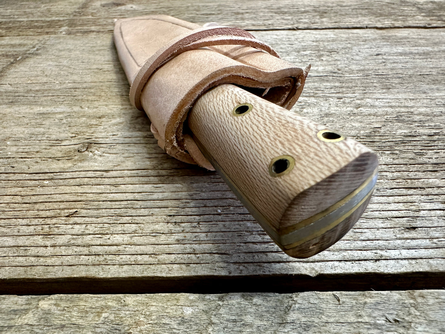 
                  
                    Small cooks knife in scabbard viewed from the top
                  
                