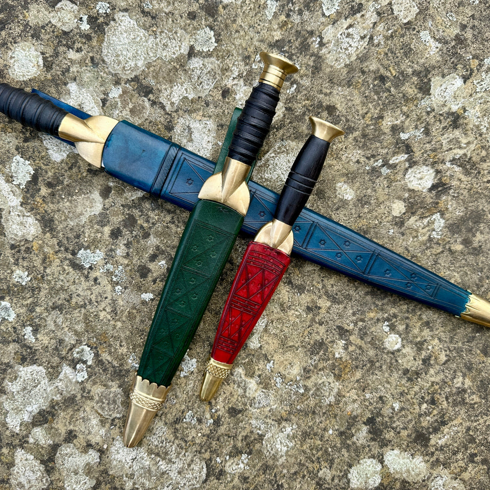 
                  
                    The Highland Bundle. Three dirks in scabbards. Blue, green and red. 
                  
                