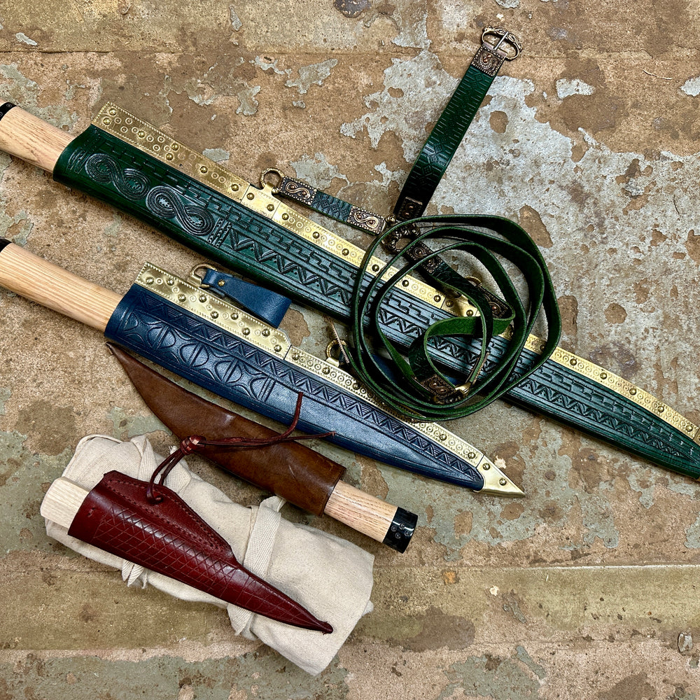 Bundle of Sword Seax, Langseax, Viking everyday carry and viking eating knife in their scabbards with a cotton sword bag rolled up next to them. 